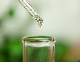 A drop of liquid flowing down a pipette, biochemical research, chemical reactions, discovery of new substances
