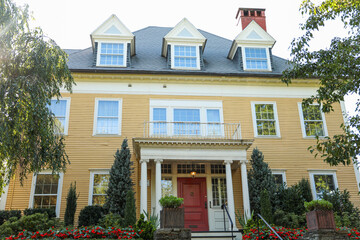 suburban house under stormy clouds, symbolizing the housing crisis, rising mortgage rates, and the struggle of homeownership in turbulent times