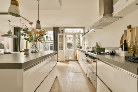 Interior of modern kitchen with island and counter