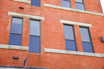 brick building in a vibrant city, symbolizing success and growth in the commercial real estate business. Modern, urban, and prosperous