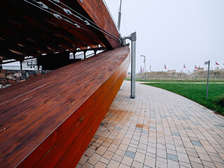 Exterior details of a city concert hall made from wood, stone and metal material. Nobody. Mist in the background. Modern design and architecture