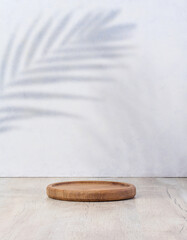 Wooden empty decorative plate on white background, product and cosmetic display stage.