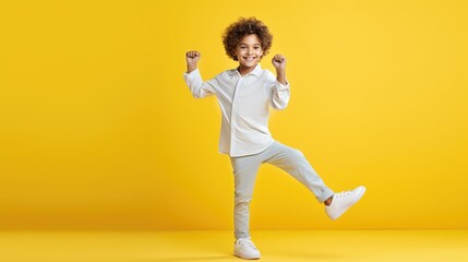Fototapeta na wymiar Portrait of a Boy Striking a Playful Dance Pose, Radiating Youthful Energy Against a Vibrant Yellow Studio Canvas with Copy Area- generative AI, fiction Person
