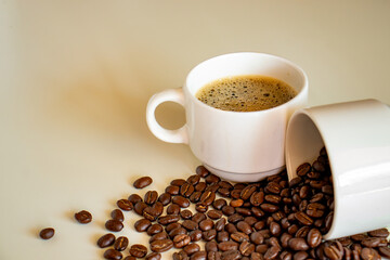 Coffee cups on off white background  full of coffee beans and coffee drink