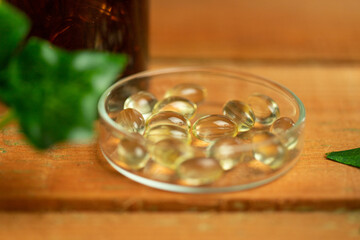 Gold pills in glass container, d3k2 supplement, vitamins and minerals