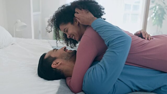 Excited, home and couple hug on bed for cuddle, love and healthy relationship for bonding, trust and care. Dating, morning and happy man and woman embrace in bedroom for sleeping, comfort and fun