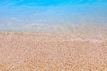 Fototapeta na wymiar Seashore of small white pebbles on the beach in Oludeniz, blue lagoon. The cleanest beach with blue flag. Background