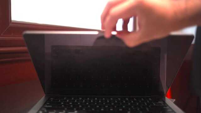Laptop with green screen in an office.