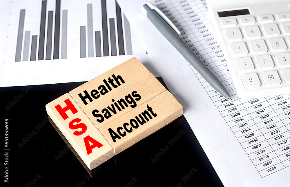 Poster word hsa made with wood building blocks with chart and calculator