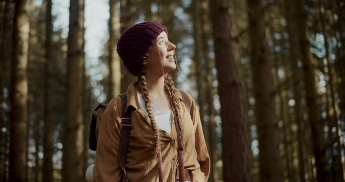 Young woman wearing knitted hat in forest