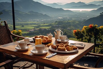 Breakfast with coffee and fresh pastries on the terrace overlooking the mountains - obrazy, fototapety, plakaty