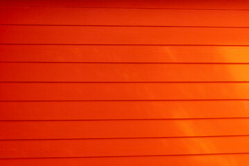 Texture of a red wooden wall. Beautiful wooden boards of red color.