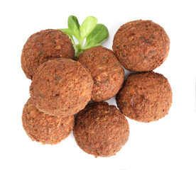 Delicious falafel balls and lambs lettuce on white background, top view. Vegan meat products