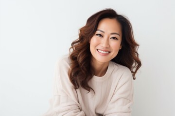 Obraz premium Lifestyle portrait photography of a Vietnamese woman in her 30s wearing a cozy sweater against a white background