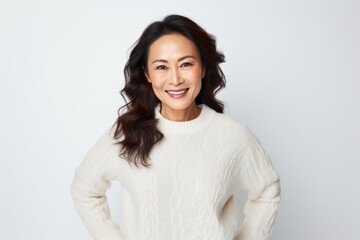 Obraz premium Medium shot portrait photography of a Vietnamese woman in her 40s wearing a cozy sweater against a white background