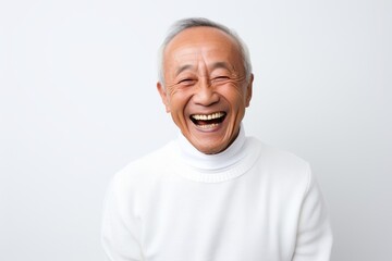 Lifestyle portrait photography of a happy Vietnamese man in his 80s against a white background