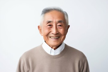 Obraz premium Medium shot portrait photography of a happy Vietnamese man in his 80s against a white background