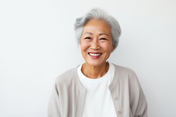 Medium shot portrait photography of a cheerful Vietnamese woman in her 90s against a white background