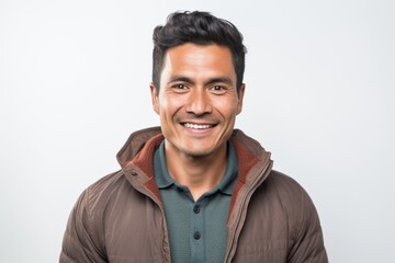 Fototapeta premium Lifestyle portrait photography of a serious Peruvian man in his 30s against a white background
