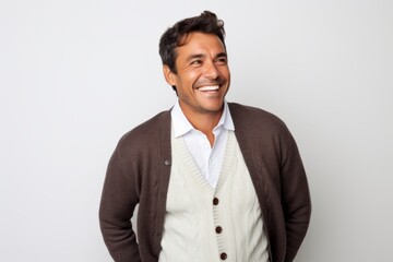 Portrait photography of a happy Peruvian man in his 30s against a white background