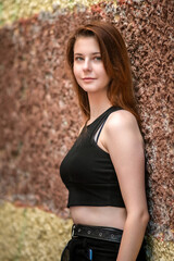 Portrait of a young beautiful long-haired girl in an urban environment.