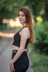 Portrait of a young beautiful long-haired girl in an urban environment.