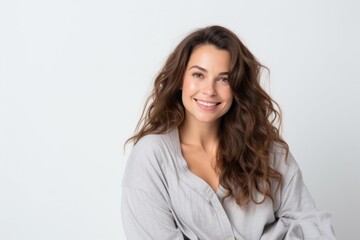 Medium shot portrait photography of a French woman in her 30s wearing a snuggly pajama set against a white background