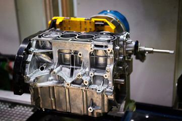 Engine cylinder block with installed pistons in workshop