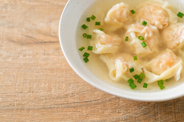 shrimp dumpling soup in white bowl