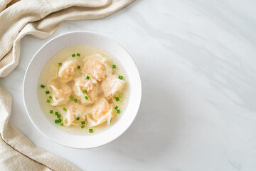 shrimp dumpling soup in white bowl