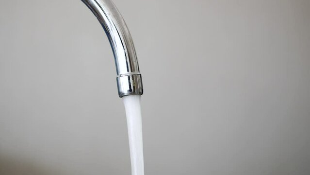 water pouring from a faucet tap slow motion 