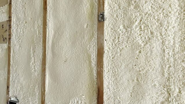Environmentally  friendly housing insulation covering a house. insulation fills up a frame on a wooden wall house under construction. Close up view