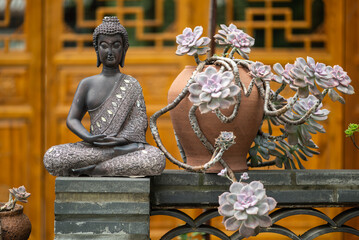 Bronze buddha statue against temple facade in Daci temple, downtown Chengdu, Sichuan province, China - 651408473