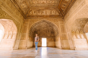 tourists and  the architectural wall of Agra Fort, India 
