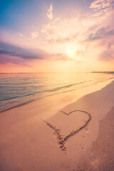 Heart drawn in sand of tropical beach coast at sunset. Peaceful golden turquoise ocean waves. Maldives islands romantic honeymoon proposal background. Couple destination scenic fantastic sunrise sky