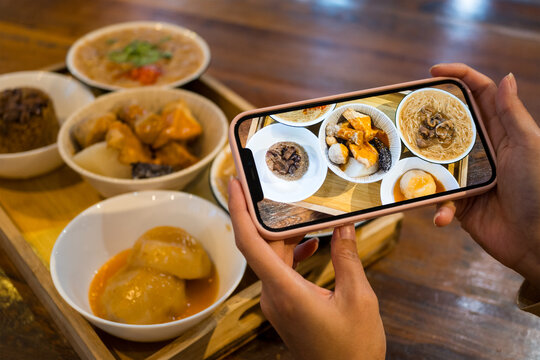 Use cellphone to take photo on the food