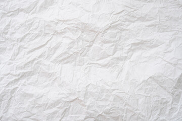 Wrinkled or crumpled white stencil paper or tissue after use in toilet or restroom with large copy space used for background texture in decorative art work