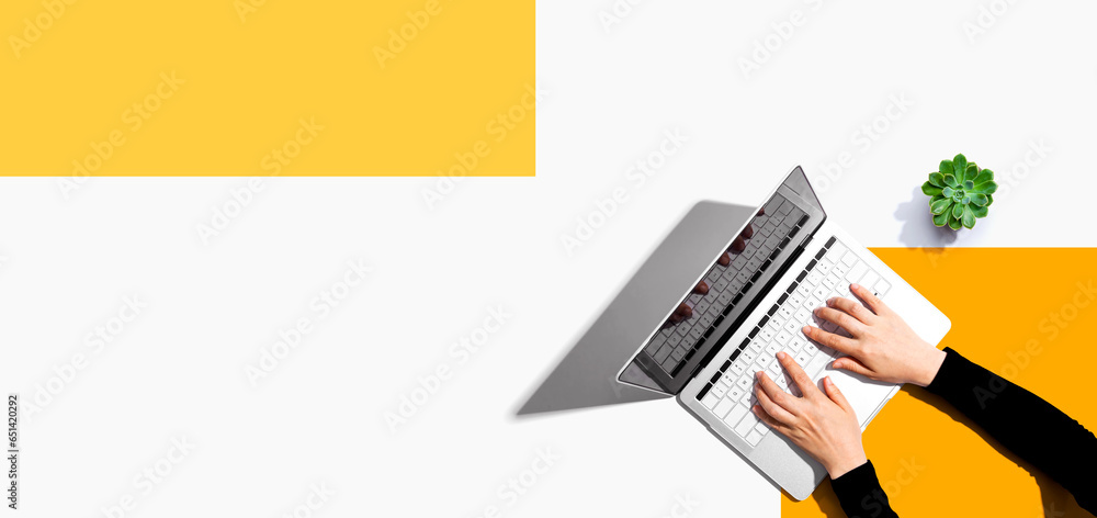 Poster person using a laptop computer from above