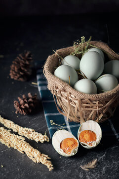 salted eggs, duck eggs in the bamboo basket and sackcloth with dark background. split salted eggs.