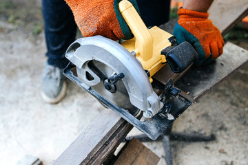 Circular saw close up. Carpenter sawing boards.Timber processing, preparation for construction.