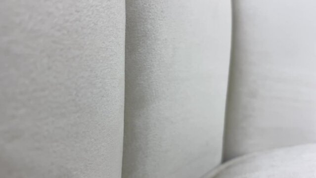 Light grey soft surface textured close up view on sofa couch. Home design and interior decoration concept