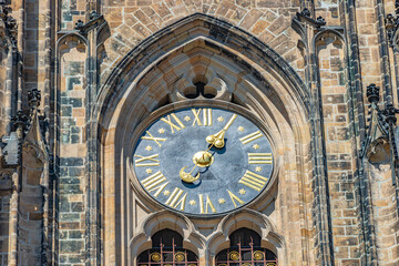 Ancient wall clock at Magnificent Saint Vitus Cathedral in Prague, Czech Republic, architecture details.