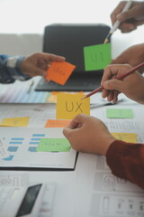 Close up ux developer and ui designer brainstorming about mobile app interface wireframe design on...