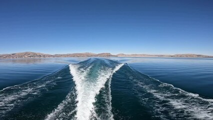 Sailing by motor boat on Titicaca lake from Puno to floating islands