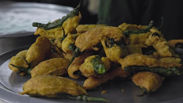 Closeup of mirchi bajji or fried fritters on the big plate at a roadside hotel