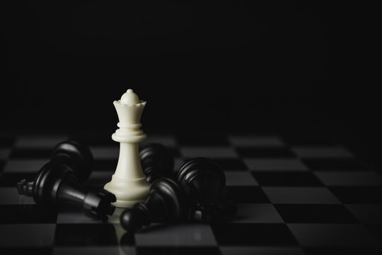 Pieces on chess board on black background for playing game and strategy.