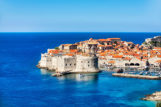 Small Boat Leaving the Harbor of Dubrovnik, Croatia, with St John's Fortress and the Old City