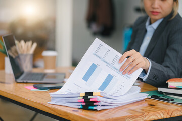 Financial analyst or accountant analyze business financial reports on a digital laptop to planning...