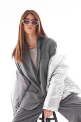 Fashion asian female model in silver down jacket and grey suit. - 651440037
