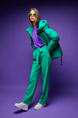 Fashion asian female model in green down jacket and pants.